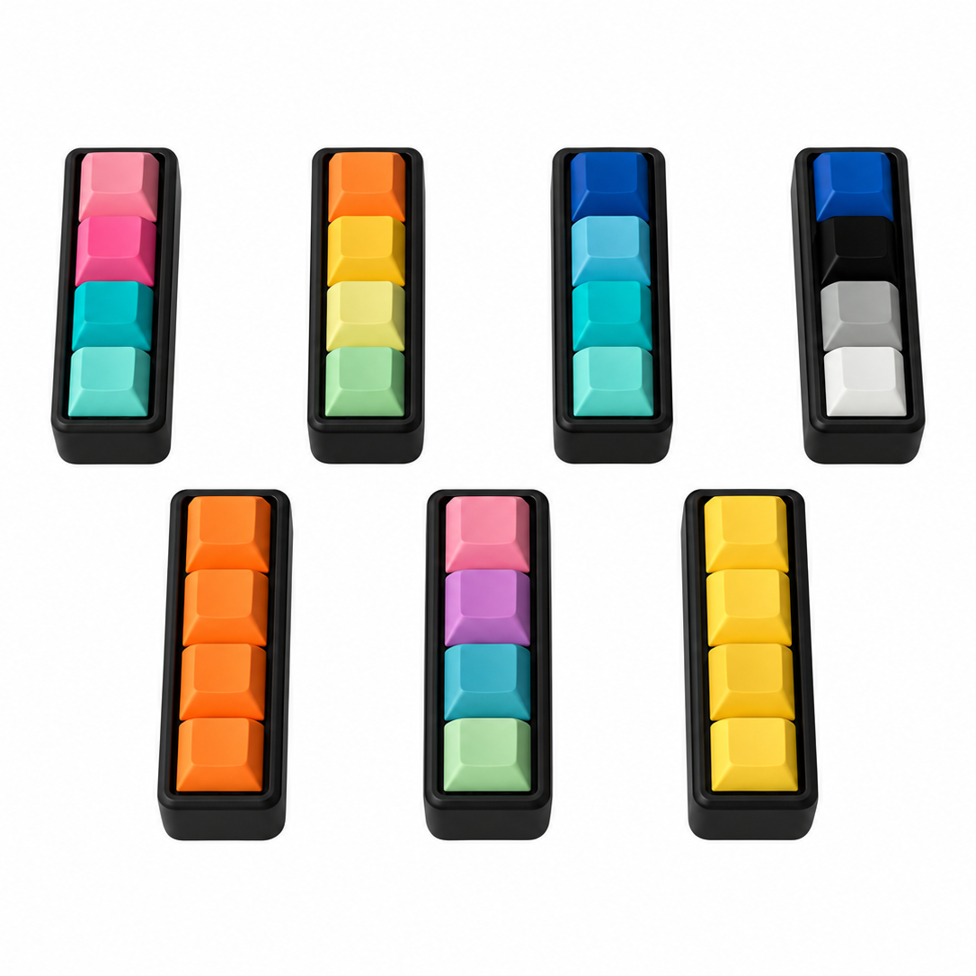 Angled view of seven Classic 4-key bar keyboard fidgets with black bases in different keycap color combinations.