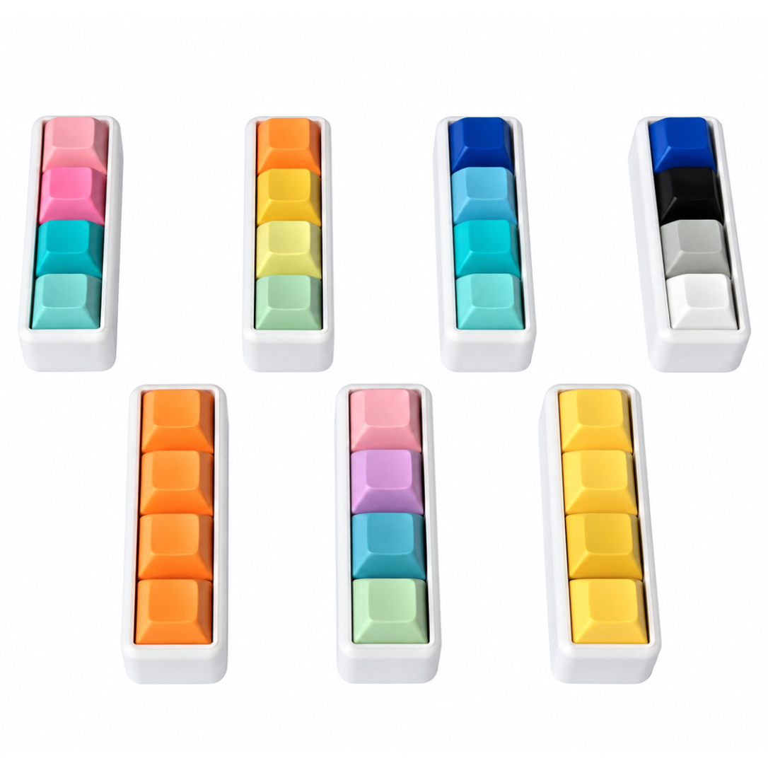 Angled view of seven Classic 4-key bar keyboard fidgets with white bases in different keycap color combinations.