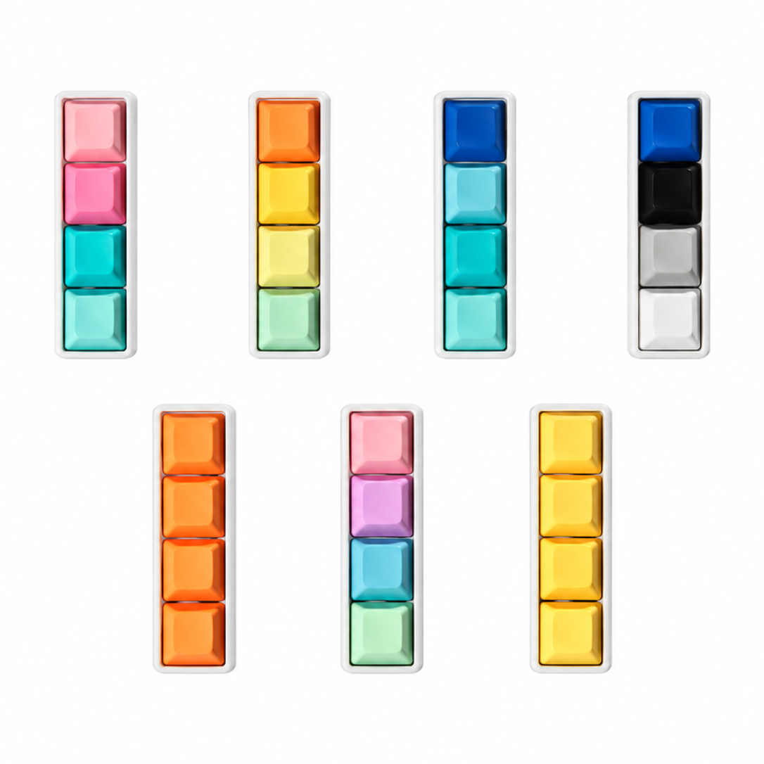 Top view of seven Classic 4-key bar keyboard fidgets with white bases in different keycap color combinations.