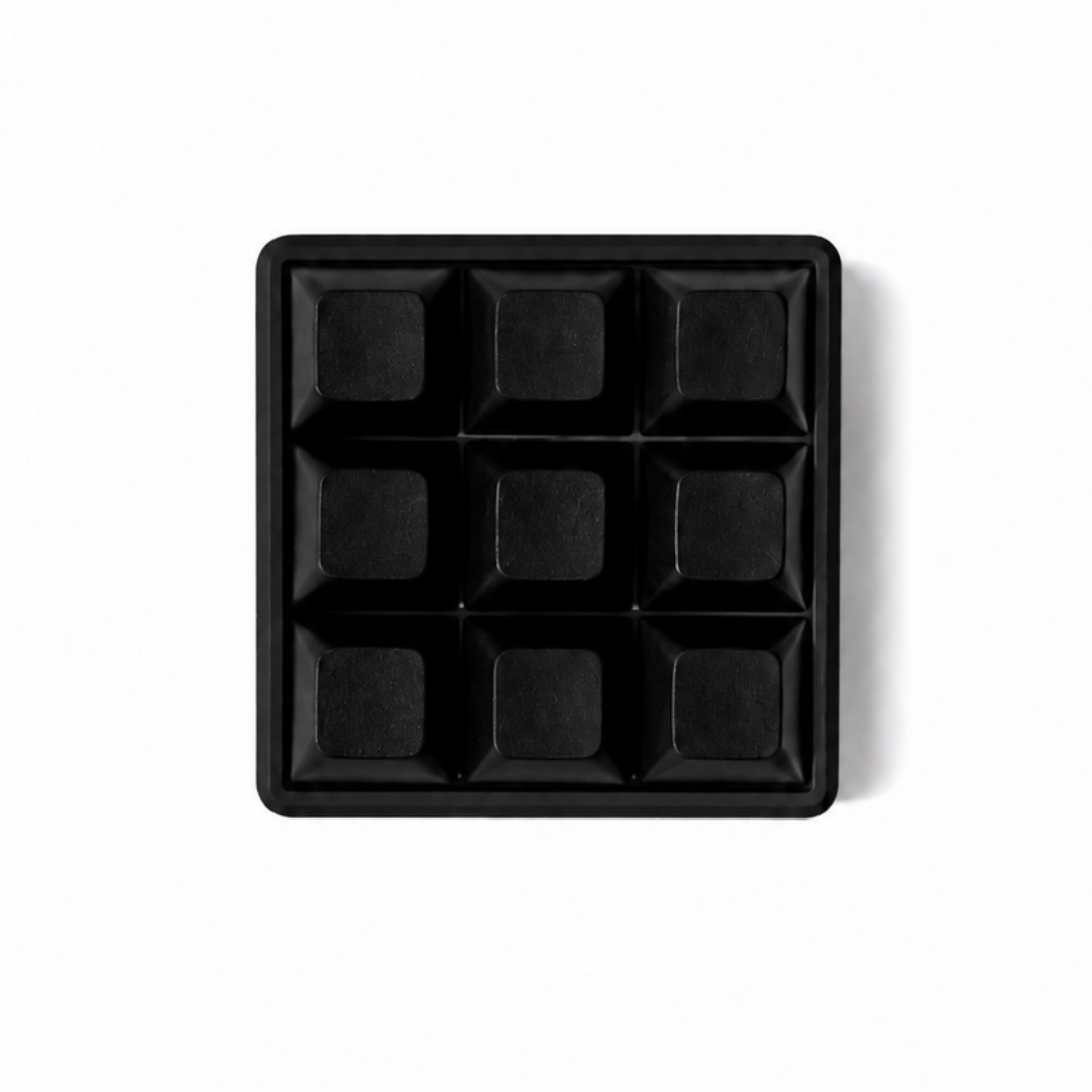 The Original 9-key square fidget with solid black keycaps on a black base.