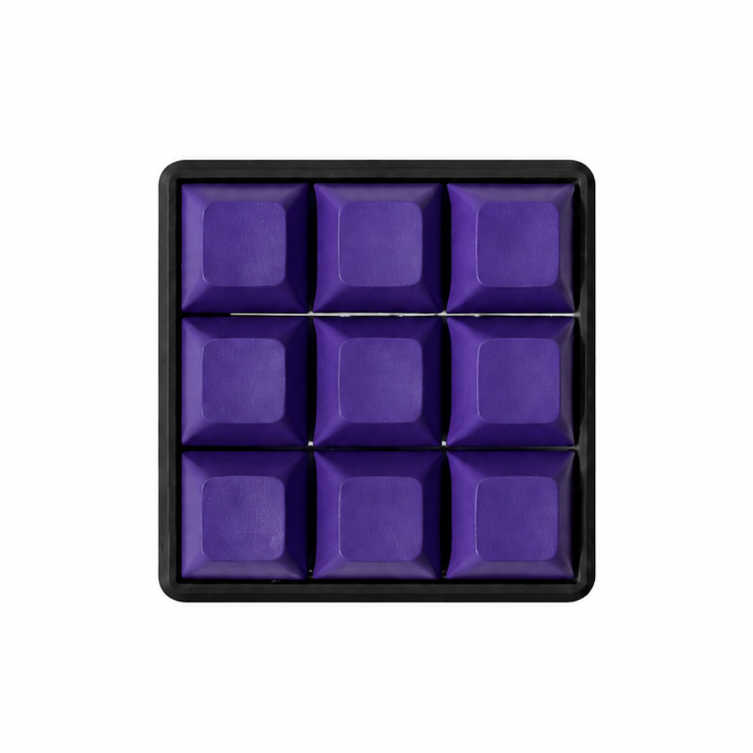The Original 9-key square fidget with solid dark purple keycaps on a black base.