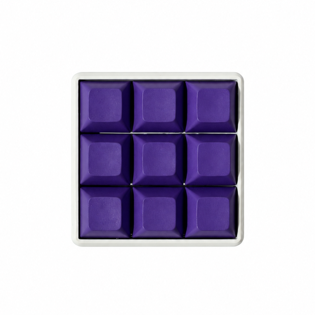 The Original 9-key square fidget with solid dark purple keycaps on a white base.