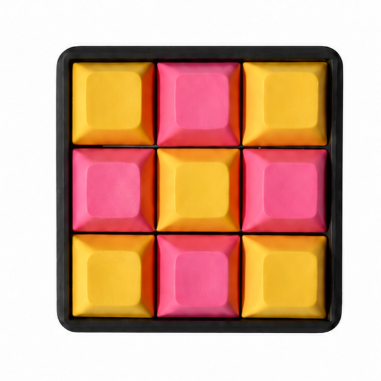 The Original 9-key square fidget with pink and yellow keycaps on a black base.