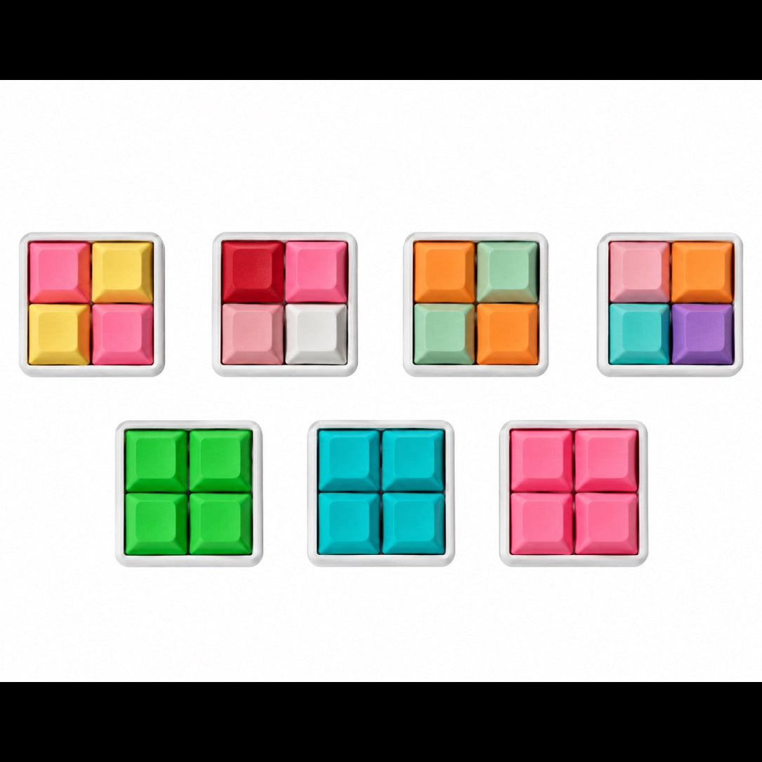 Top view of seven Pocket 4-key square keyboard fidgets with white bases in different keycap color combinations.