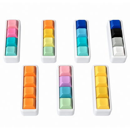 Angled view of seven Classic 4-key bar keyboard fidgets with white bases in different keycap color combinations.