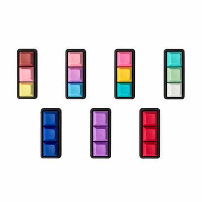 Top view of seven Mini 3-key keyboard fidgets with black bases in Peach Sorbet, Daydream, Electric Splash, Sea Breeze, Blue, Lavender, and Red.