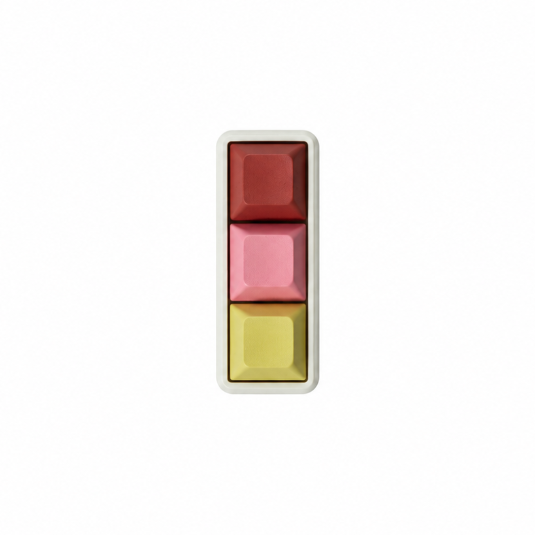 The Mini 3-key fidget in Peach Sorbet, with terracotta, pink, and light yellow keycaps and a white base.