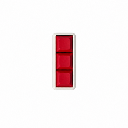 The Mini 3-key fidget with solid red keycaps and a white base.