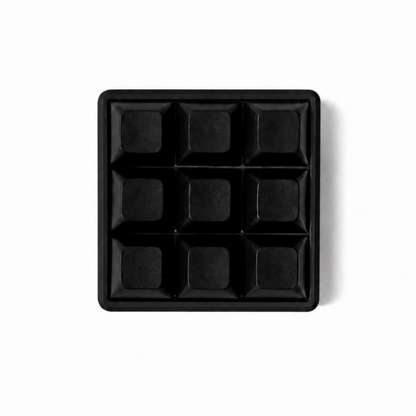 The Original 9-key square fidget with solid black keycaps on a black base.