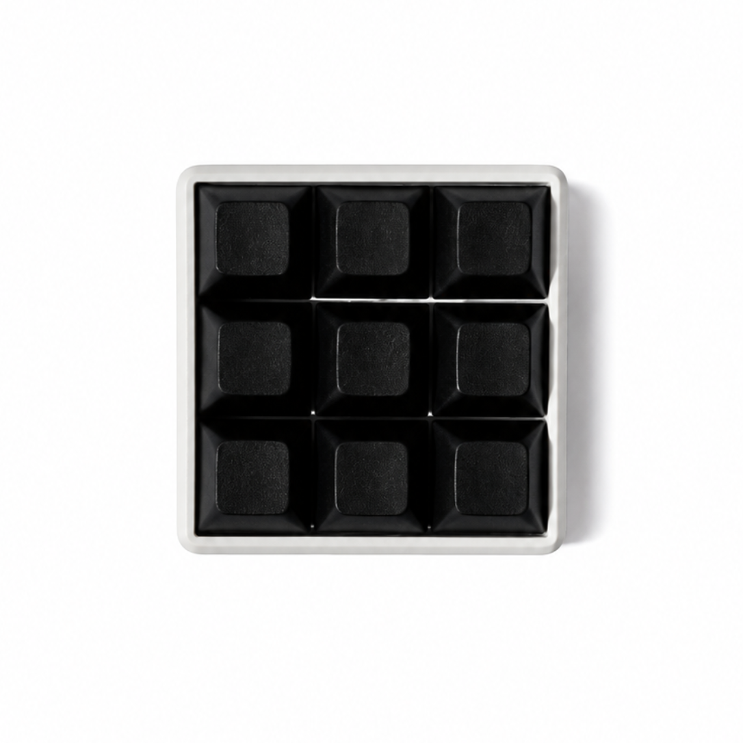 The Original 9-key square fidget with solid black keycaps on a white base.