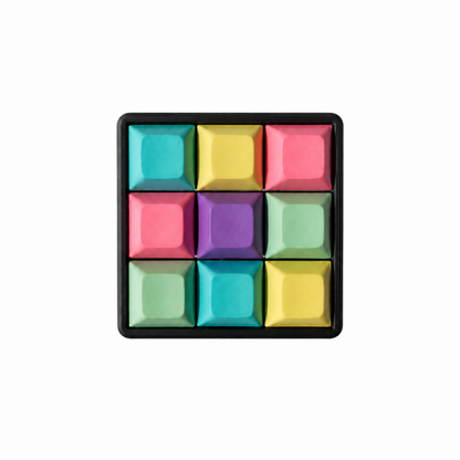 The Original 9-key square fidget with cyan, yellow, pink, lavender, and mint green keycaps on a black base.