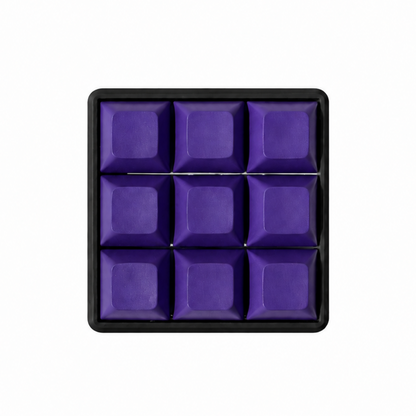 The Original 9-key square fidget with solid dark purple keycaps on a black base.