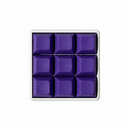 The Original 9-key square fidget with solid dark purple keycaps on a white base.