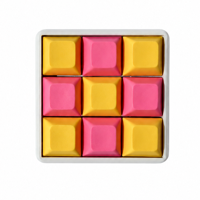 The Original 9-key square fidget with pink and yellow keycaps on a white base.